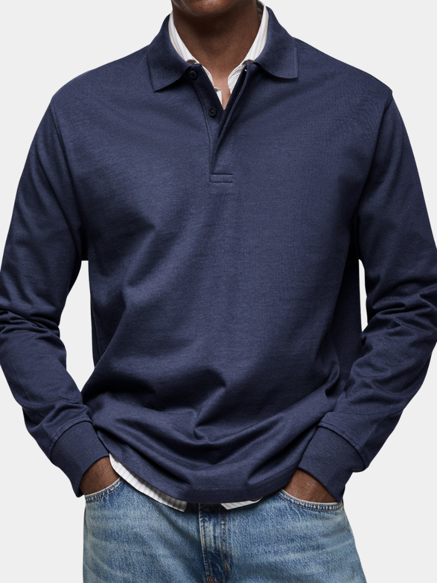 Navy blue heathered long-sleeve polo shirt worn with jeans on a gray background