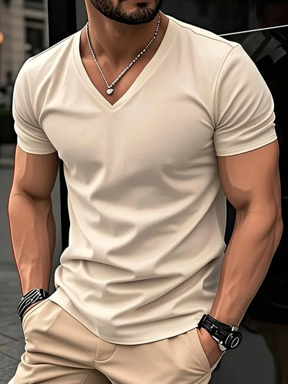Khaki slim V-neck T-shirt worn with beige trousers