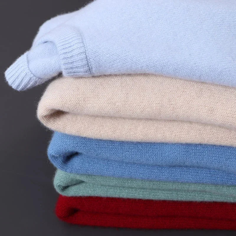 Fine-knit crew neck sweaters folded in a stack of colors