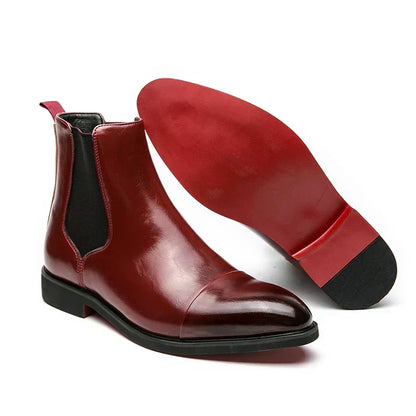 Burgundy cap-toe Chelsea boot with black elastic panel, beside the red sole