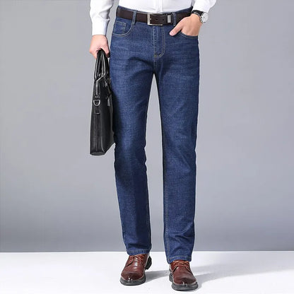 Blue slim-fit five-pocket jeans worn with a gray shirt