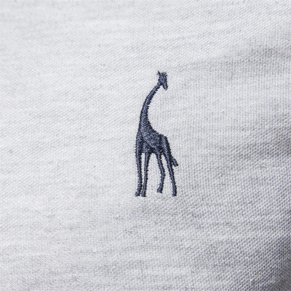 Close-up of the embroidered chest detail on the gray polo shirt