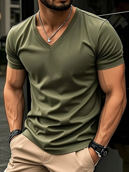Green slim V-neck T-shirt worn with beige trousers