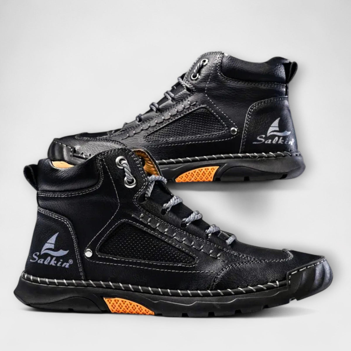 Pair of black lug-sole stitched ankle boots