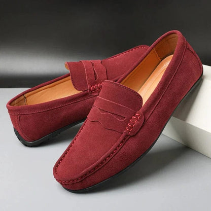 Red suede penny loafers with whip-stitched penny strap
