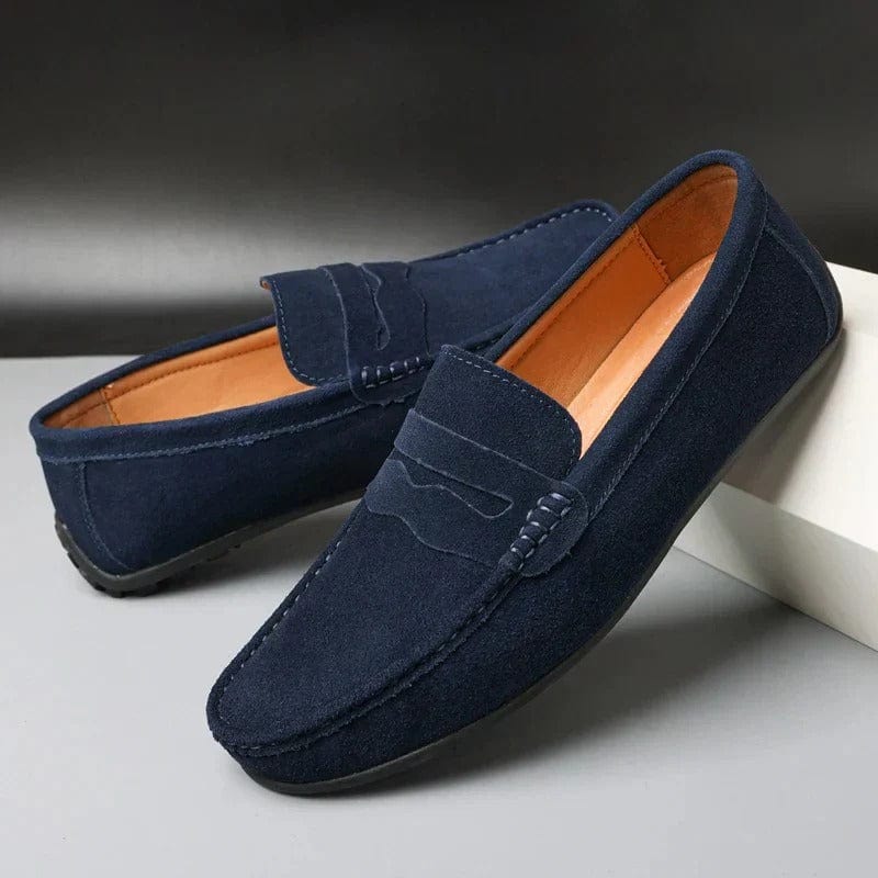Pair of navy blue suede penny loafers with moc toe